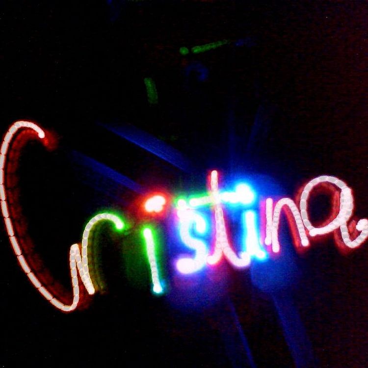 Lichtkunst-Werkstatt Leuchtender Schriftzug "Christina". Dieser wurde mit verschieden farbigen Lichtquellen in einen dunklen Raum gemalt.